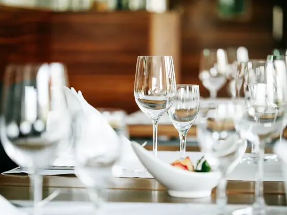 A close up of a restaurant table mis en place, prepped and set up ready for customer.