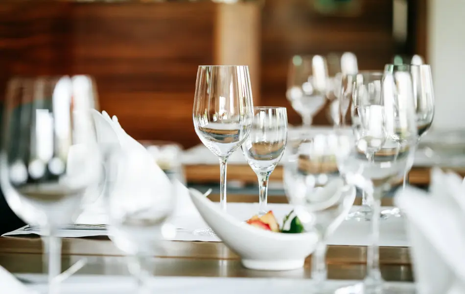 A close up of a restaurant table mis en place, prepped and set up ready for customer.