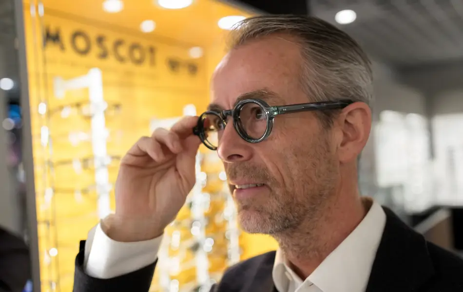 Geir Krogh holder seg på brillen og ser til siden.