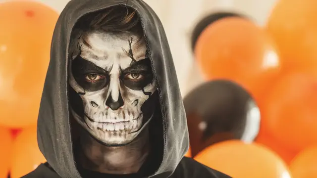 Copy space shot of young man disguised as grim reaper. 