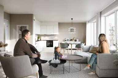En mann, kvinne og barn sitter i en stylet stue i en leilighet på Skårerløkka Premium.
