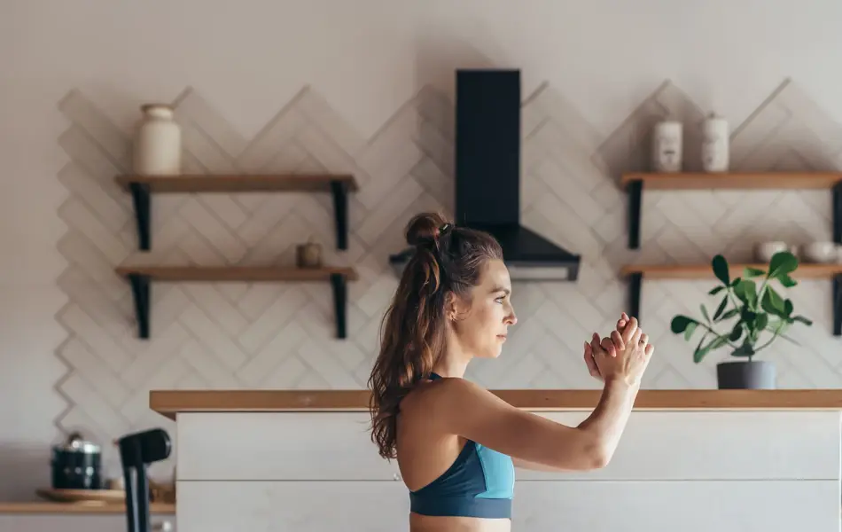 Fit woman exercising at home doing lunges exercise