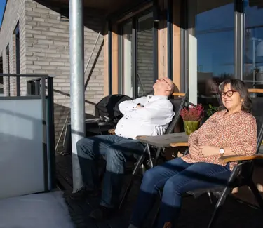Bilde av Henning Granum og Torill Fjæran-Granum som sitter i hver sin stol på verandaen deres på Skårerløkka