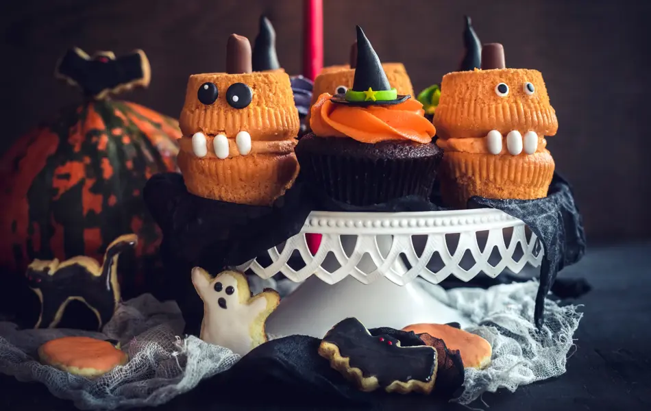 Scary Halloween cup cakes served on the table,selective focus