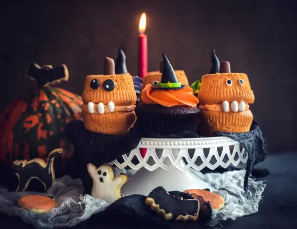 Scary Halloween cup cakes served on the table,selective focus