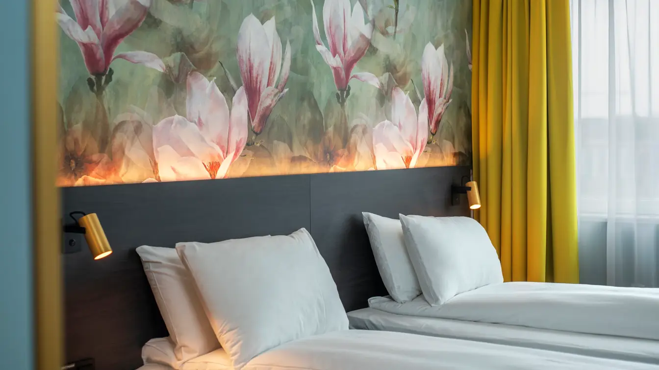 Blomstertapetvegg, dobbeltseng, vindu, gule gardiner