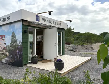 Bilde av fasaden til visningssenteret til boligprosjektet Heggedal Hage.