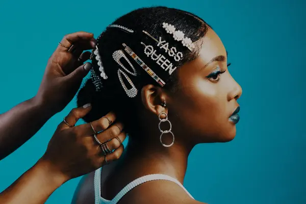 Studio shot of a stylist adding hair clips to a woman's hair