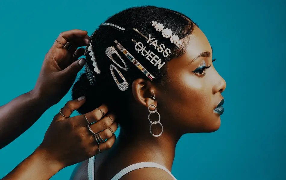 Studio shot of a stylist adding hair clips to a woman's hair