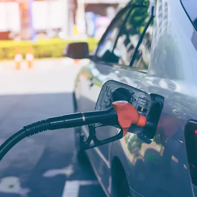 Pumping gasoline fuel in car at gas station