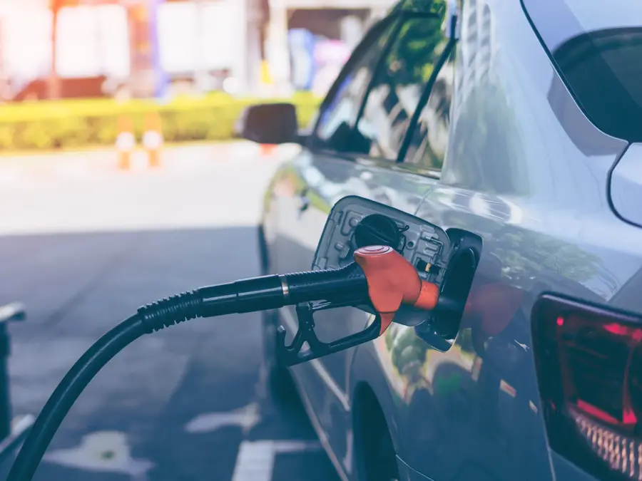 Pumping gasoline fuel in car at gas station
