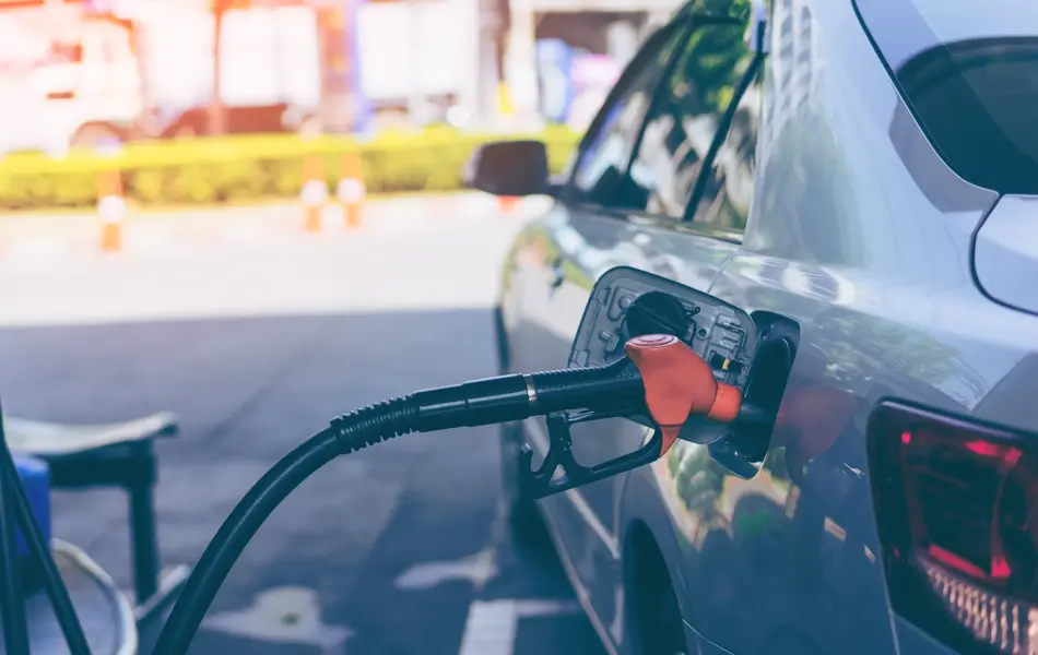 Pumping gasoline fuel in car at gas station
