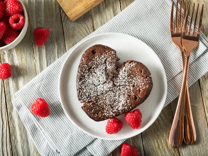 Hjerteformet brownie med melisstrøssel med bringebær rundt