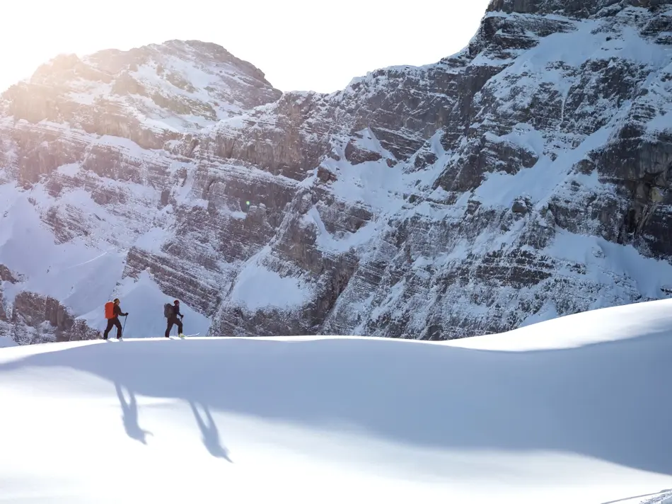 Fjellandskap med masse snø og to skigåere