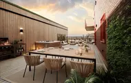 3D illustrasjonen vises takterrassen på en leilighet i boligprosjektet Skårerløkka PREMIUM. En moderne takterrasse med lyse tremøbler og grønne planter. I bakgrunnen ser man byens silhuett i solnedgang.