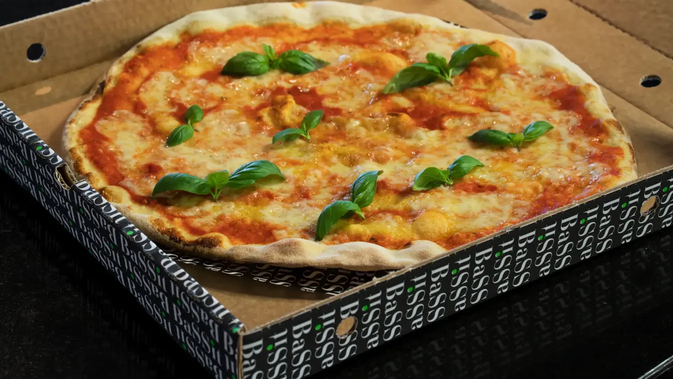 Nærbilde av pizza i pizzaeske på Thon Hotel Oslo Airport