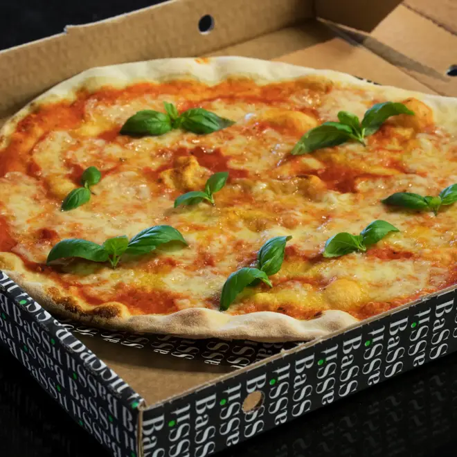 Nærbilde av pizza i pizzaeske på Thon Hotel Oslo Airport