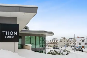 Fasadebilde av Thon Senter Ulsteinvik, med logo på vegg.