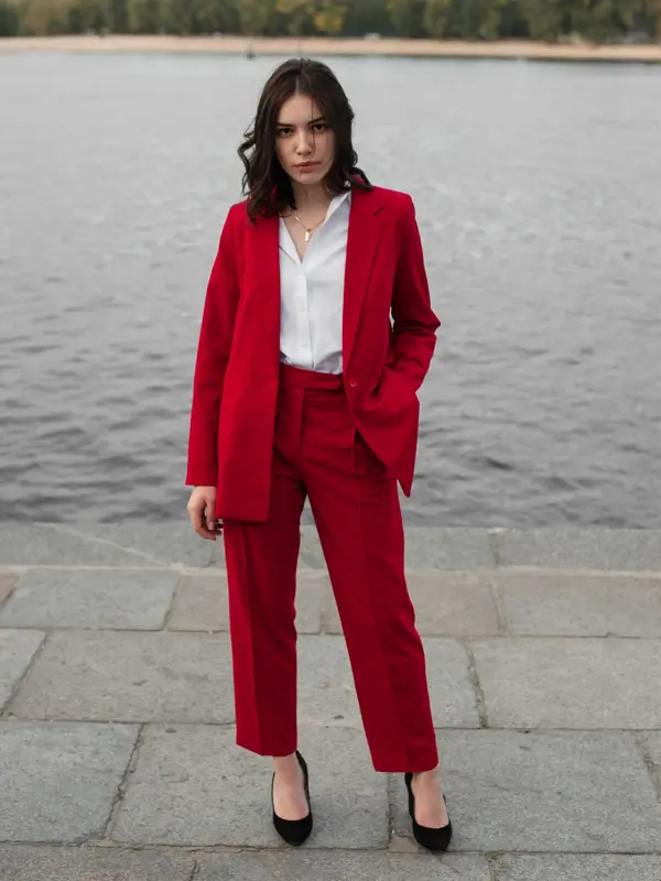 Young Caucasian woman in red pantsuit  walking in the city