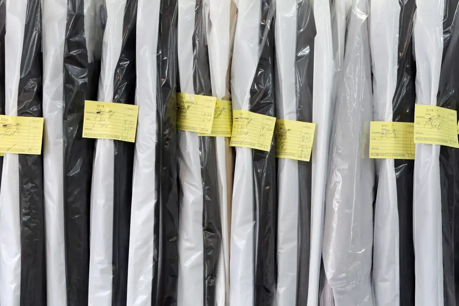 Completed dry cleaning hung neatly ready for collection.