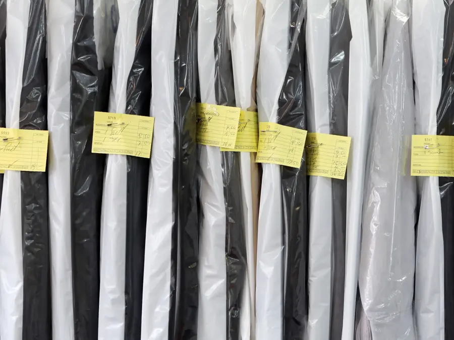Completed dry cleaning hung neatly ready for collection.
