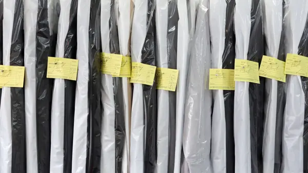 Completed dry cleaning hung neatly ready for collection.