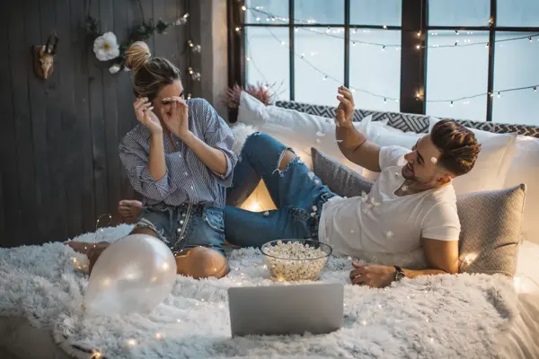 Couple on Valentine day enjoy in love. They are in bed and having romantic moment together