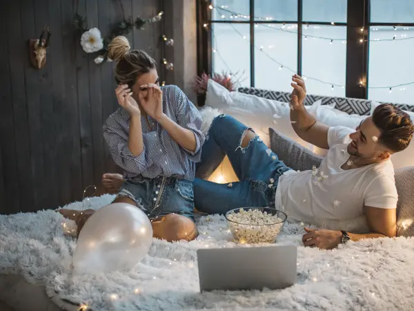 Couple on Valentine day enjoy in love. They are in bed and having romantic moment together