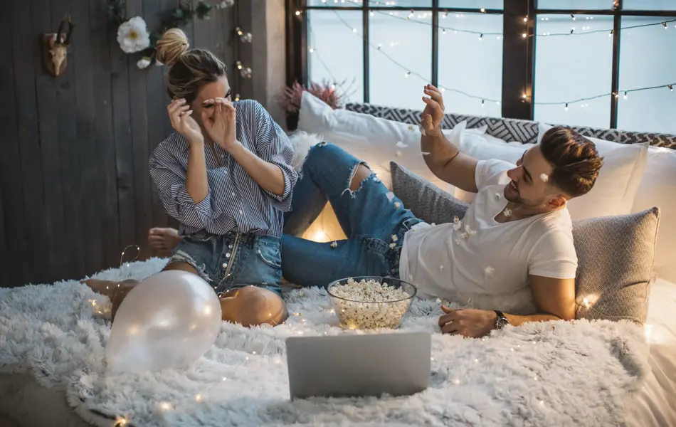 Couple on Valentine day enjoy in love. They are in bed and having romantic moment together