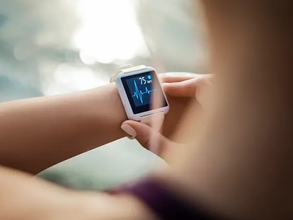 Sporty Woman Looking At Her Smart Watch