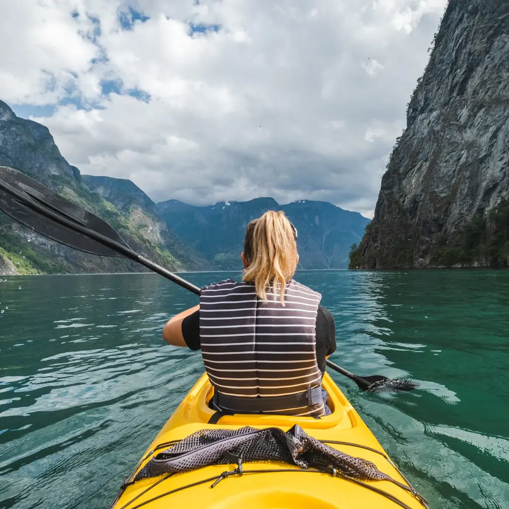 Woman kayaking in Gudvangen in Norway.