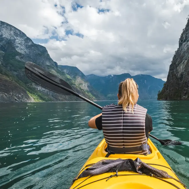 Woman kayaking in Gudvangen in Norway.