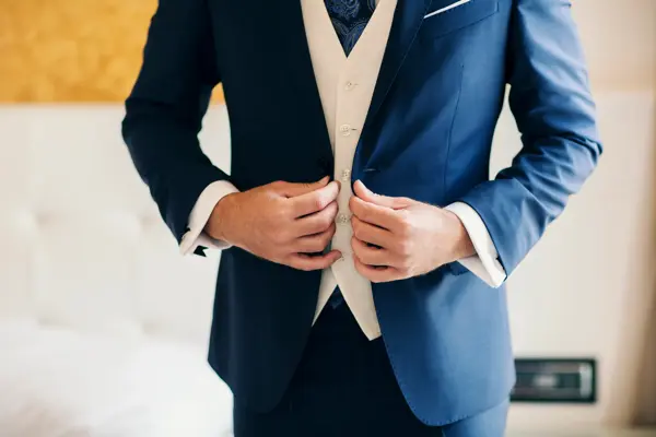 Businessman or groom getting dressed