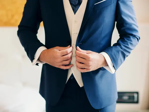 Businessman or groom getting dressed