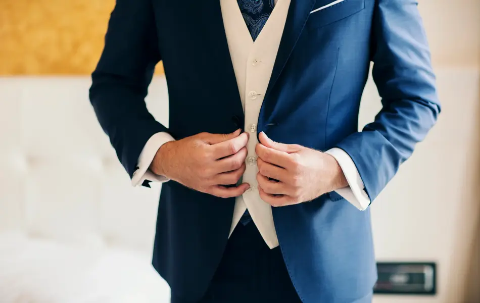 Businessman or groom getting dressed