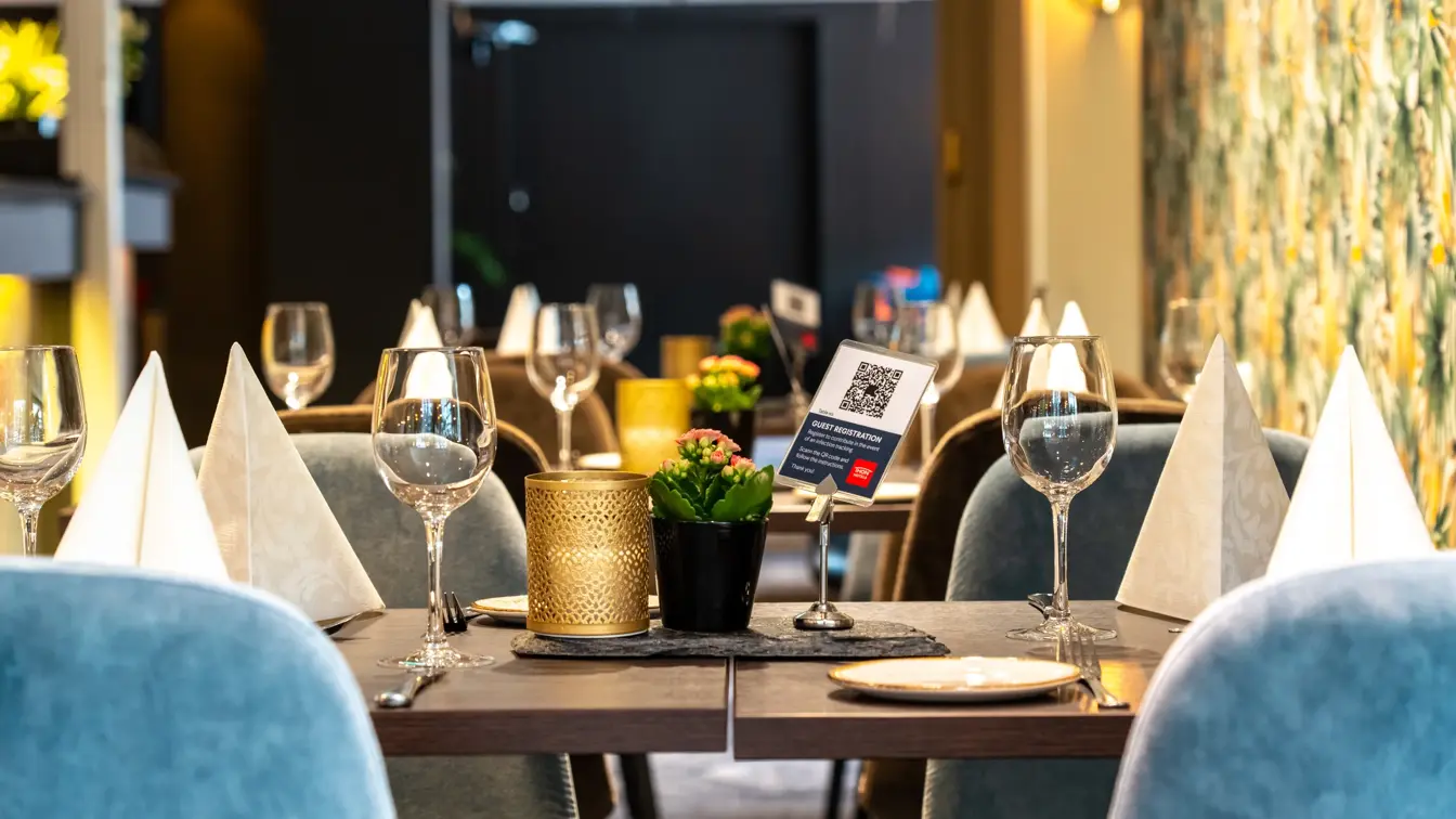 Spisebord, dekket bord, blå stoler.