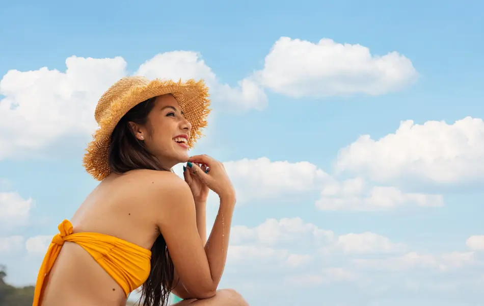 Rear view of woman relaxing on tropical beach