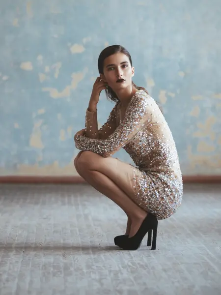 Portrait of fashionable woman in sequin dress. Professional make-up and hairstyle.