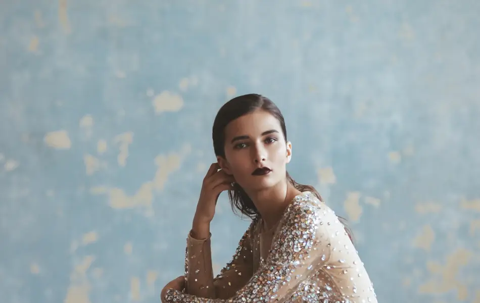Portrait of fashionable woman in sequin dress. Professional make-up and hairstyle.