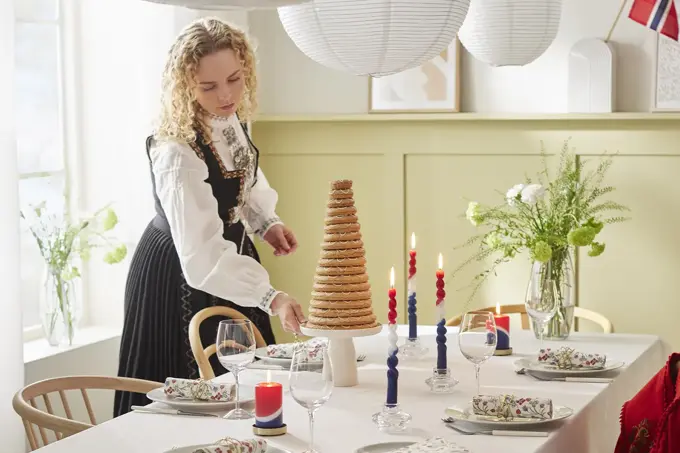 Dame som dekker på et bord til 17. mai