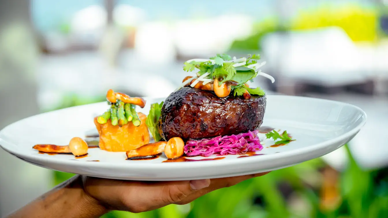 Meat with potatoes and asparagus on a white plate. The Restaurant