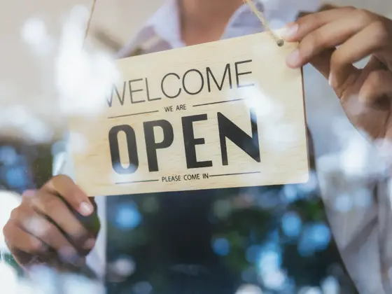 Young startup coffee cafe owener open and welcome customer. New small business owener.