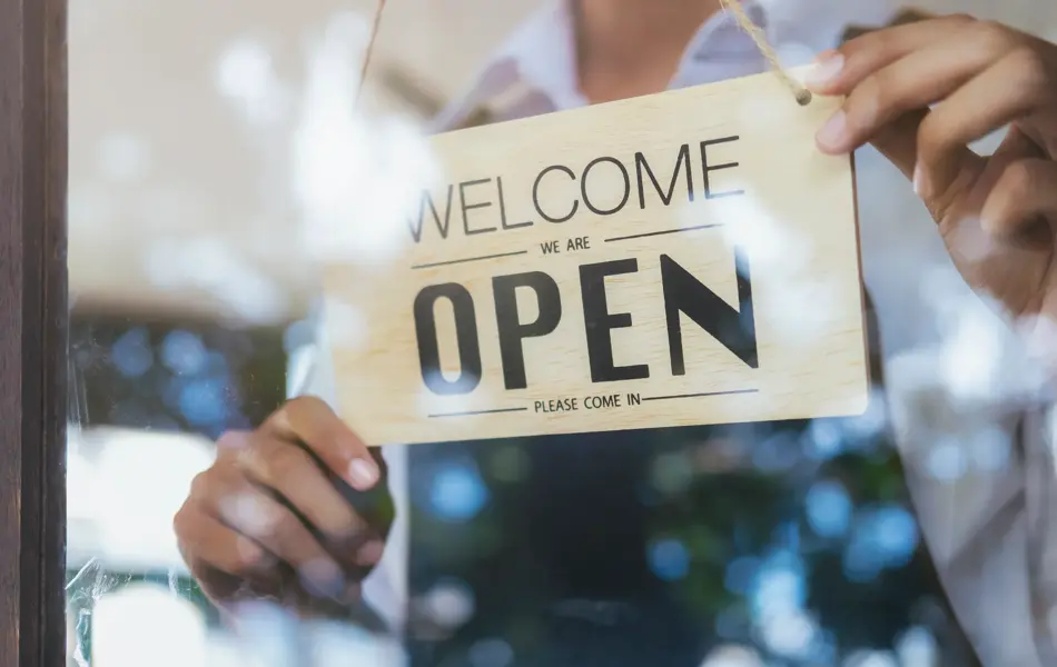 Young startup coffee cafe owener open and welcome customer. New small business owener.