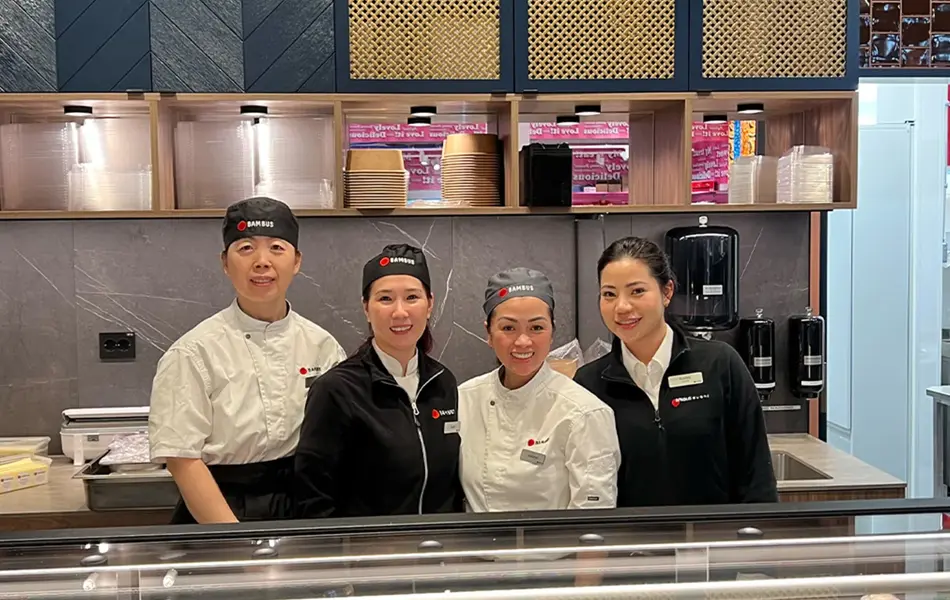 Fire personer som står bak disken