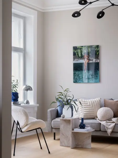 Stue med sofa, bord, stol og bilde på veggen