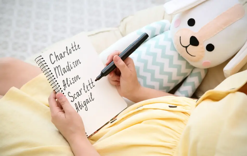 Pregnant woman with baby names list sitting in armchair, closeup
