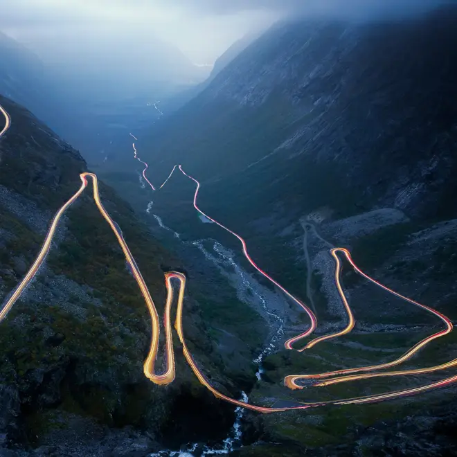 Light trails on the Trollstigen road in Norway at night . .