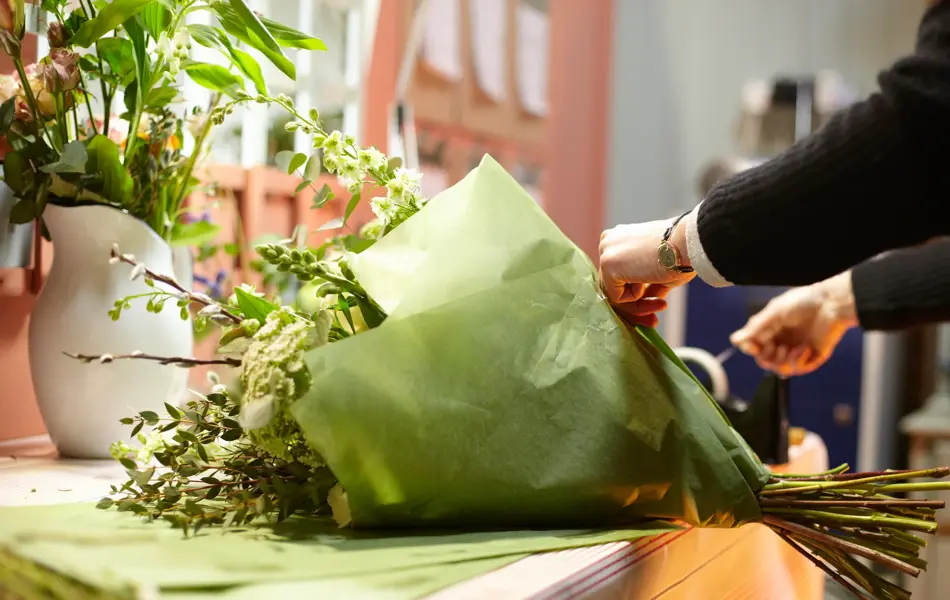 Flowers in the bouquet are; Avalanche white roses, Larkspur, Wax flower, Antirrhinum, Viburnum opulus, Alstroemeria and Ammi visnaga