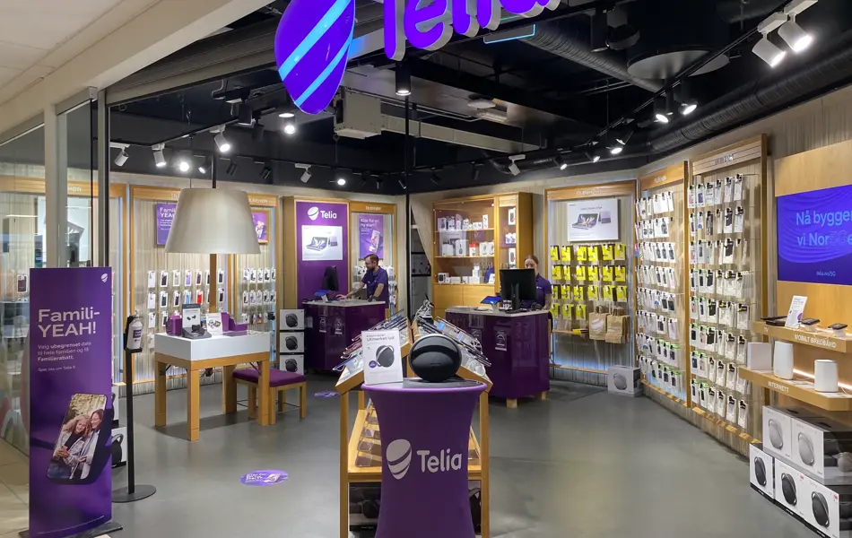 Innendørs butikk med lilla lys og skilter og reoler