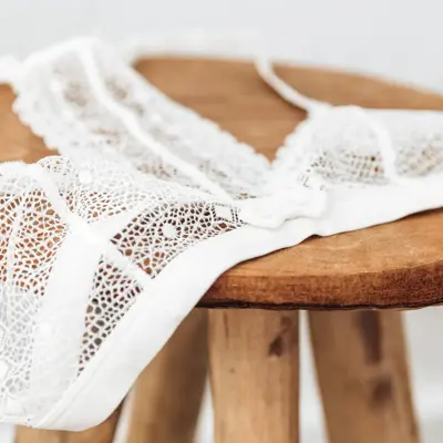 White delicate lace bra on a wood  stool